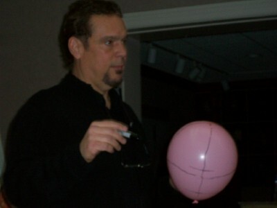 Daryl draws onto a pink balloon